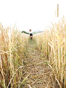 During Walk Through Field Of Wheat Young Redhead Takes A Break T
