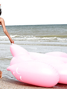 Short-Haired Brunette With A Great Tan Poses Next To Inflatable