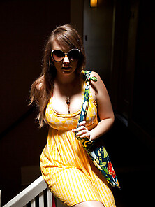 Busty Long-Haired Teen Posing In Yellow Dress