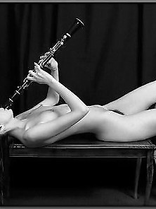 Nude Girl Blows And Play A Clarinet Music Instrument