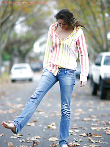 Teen In Striped Shirt And Jeans Walks The Streets And Strips On
