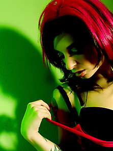Joanna Angel Strips In Front Of A Green Wall