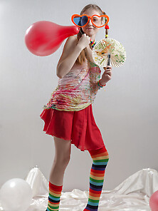 Fancy Girl With Red Balloons And In Striped Socks Bares Her Smal