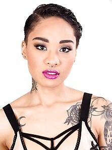 Tattooed Oriental Love With Purple Lipstick Looks Into The Camer