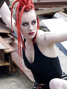 Tattooed Emo Girl With Red Dreadlocks Poses Naked In An Industri
