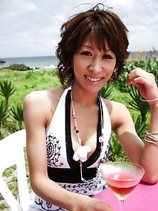Fun Asian Hottie Drinks A Martini Outdoors